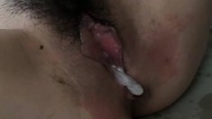 Petite Oriental girl has a guy filling her narrow cunt with his juices