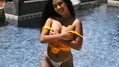 Janice poses in the pool giving a good view of her luscious ass